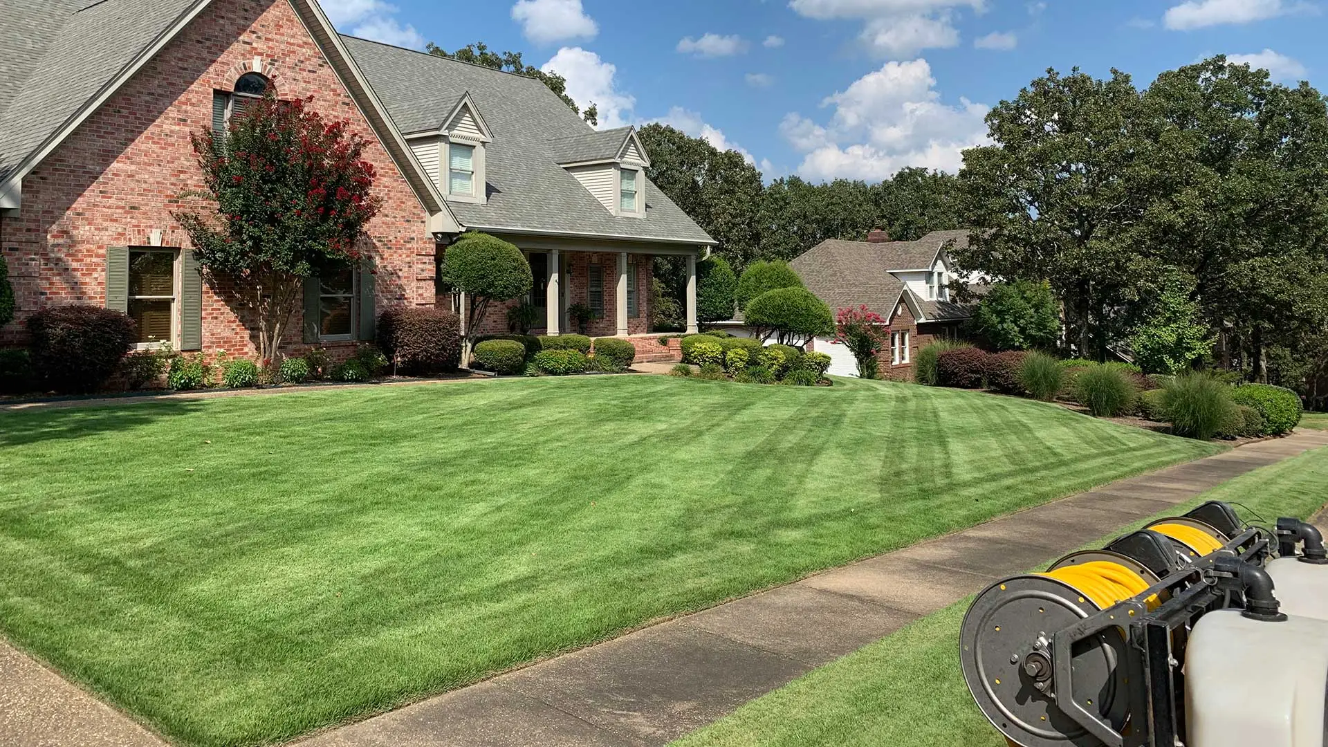 Well fertilized home lawn and red brick house in North Little Rock, AR.
