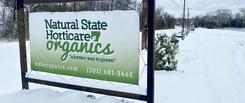 Natural State Horticare sign covered by snow near Little Rock, Arkansas.